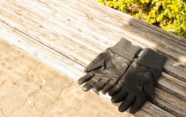  A pair of leather gloves drying in the sun.