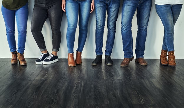 a line of women wearing jeans of all different body shapes